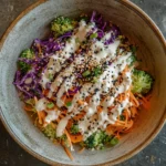 Vibrant broccoli salad with sweet miso dressing and colorful veggies in a bowl