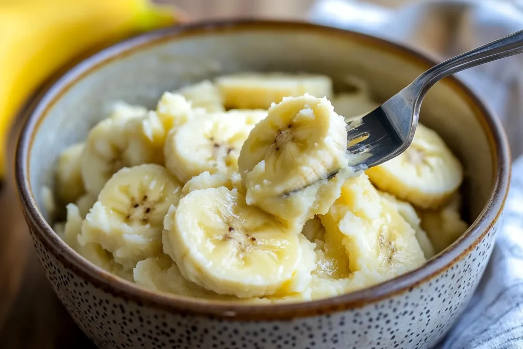 Ripe bananas being mashed in a mixing bowl
