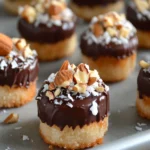Chocolate-covered frozen banana bites with toppings on a tray