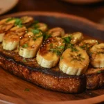 Whole grain toast with peanut butter and banana slices on a wooden plate